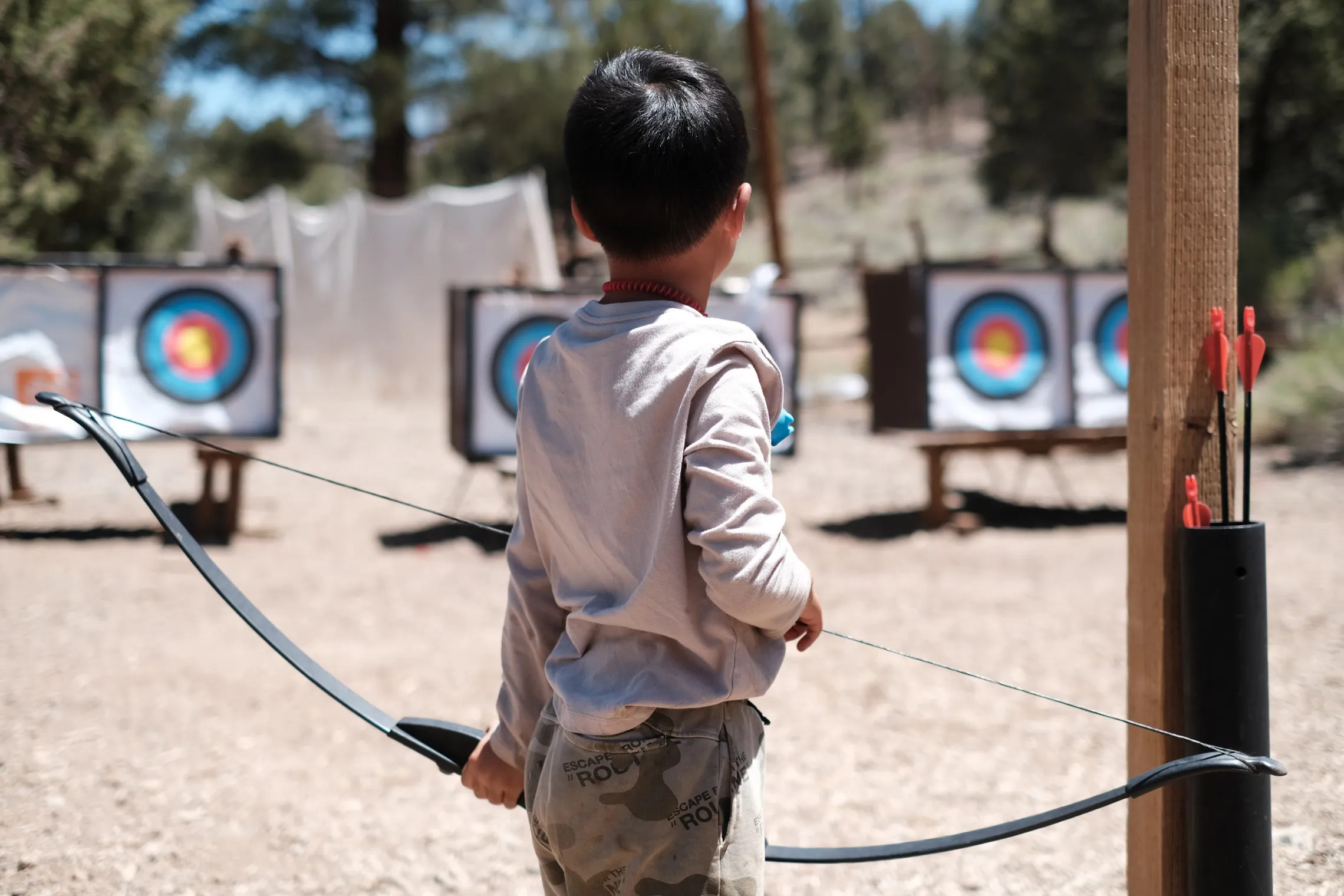 Young boy at Camp participating in Archery.